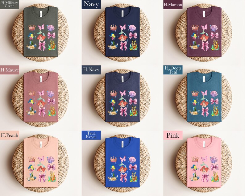 a collection of t-shirts with various colors and designs, including a mermaid theme. The t-shirts are arranged in a grid pattern, with each row containing three shirts. The shirts are placed on a woven basket or plate, which adds a rustic touch to the overall presentation.