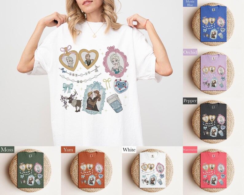 A woman is wearing a white t-shirt with various cartoon characters and illustrations on it, including a heart, a cup, and other whimsical designs.