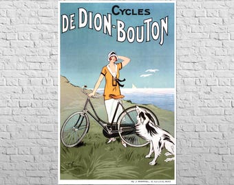 May include: Vintage poster advertising "Cycles De Dion-Bouton." The artwork depicts a woman in an orange dress and white pants standing next to a black bicycle. A black and white dog sits nearby. The background shows a beach and ocean.