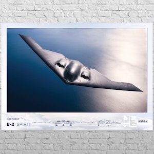 May include: A Northrop B-2 Spirit stealth bomber flies over a cloudy sky. The aircraft is painted in a silver gray color and has a distinctive flying wing design. The text "NORTHROP B-2 SPIRIT" is visible in the lower left corner of the image.