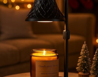 May include: A black candle warmer with a textured shade, illuminating a lit candle in a glass jar. The candle has a label with text. The warmer sits on a round base, with a blurred background.
