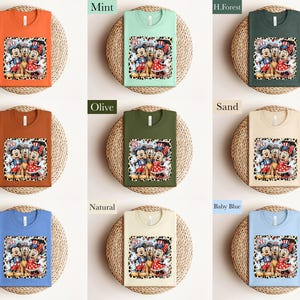 The image is a collage of nine different t-shirt designs, each with a unique color and pattern. The t-shirts are displayed on a woven basket, creating a visually appealing arrangement.