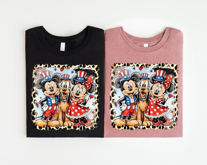two t-shirts with a cartoon-style illustration of Mickey Mouse and Minnie Mouse wearing patriotic hats and outfits.