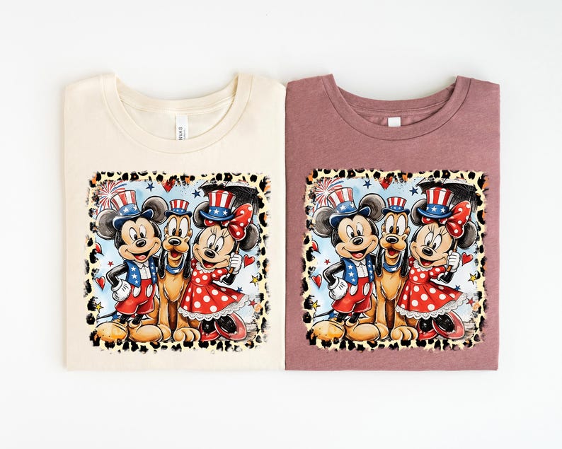 two t-shirts with a cartoon-style illustration of Mickey Mouse and Minnie Mouse, along with other Disney characters, set against a patriotic background.