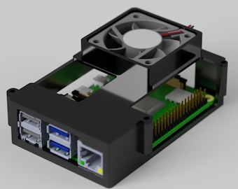 May include: Black computer case with a cooling fan on top. The case has USB ports, an Ethernet port, and a green circuit board visible inside. The fan is gray with a white center.