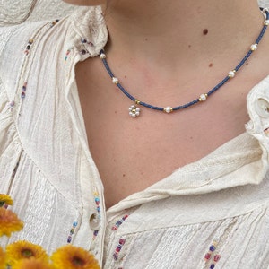 Necklace with blue and white pearly beads, flower pendant and stainless steel