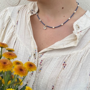 Necklace with blue and white pearly beads, flower pendant and stainless steel