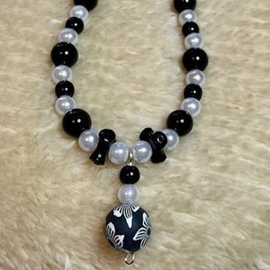 Floral Beaded Pendant Necklace: Black, White, and Pearl
