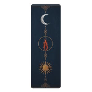 May include: A rectangular yoga mat in deep navy blue featuring a vertical alignment of celestial and elemental symbols. From top to bottom, it displays a silver crescent moon, a central orange flame inside a gold circle, and a golden sun.