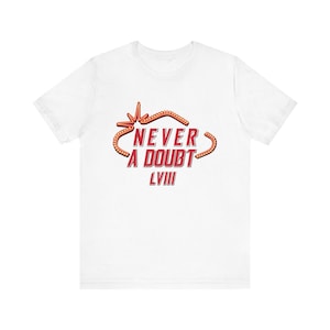 May include: White t-shirt with a red graphic that says "Never a Doubt LVIII" in a retro style.