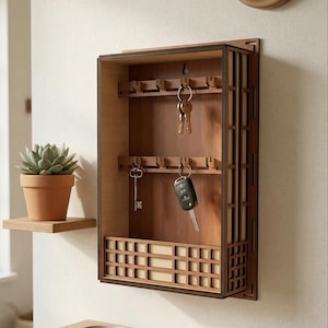 May include: A wooden key holder with a geometric design, featuring multiple hooks for keys. The key holder is mounted on a wall, with keys hanging from the hooks. A small succulent in a terracotta pot sits on a shelf nearby.
