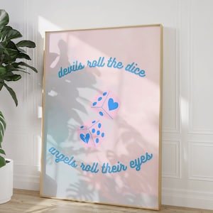 May include: A pink and blue gradient poster with the text "devils roll the dice angels roll their eyes" in blue cursive font. Two blue dice with white dots and pink hearts are in the center of the poster.