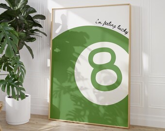 May include: A green and white poster with a white circle containing the number eight in green. The text "I'm feeling lucky" is written in black cursive above the circle.