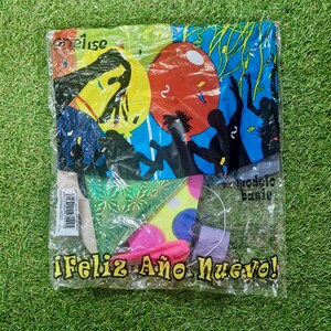 May include: A clear plastic bag filled with party supplies for a New Year's Eve celebration. The bag contains a green and gold confetti star, a yellow and red polka dot star, a pink balloon, a purple party hat, and a blue and black printed banner that says "Feliz Año Nuevo!"