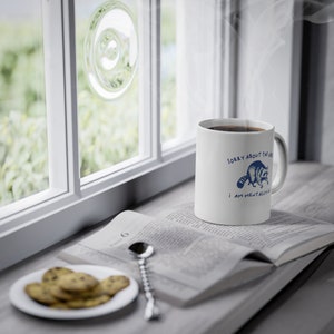 White ceramic mug with funny raccoon meme and caption Sorry About the Vibes, I Am Mentally Ill