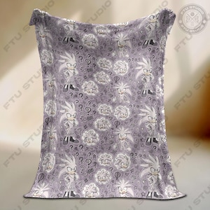 May include: A lavender blanket featuring a repeating pattern of a white hedgehog character, question marks, and other cartoon elements. The blanket is made of a soft material and is suitable for a bed or couch.