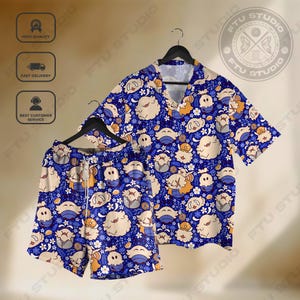 May include: A blue pajama set with a short-sleeved shirt and shorts, patterned with cartoon characters, flowers, and moons. The shirt has a V-neck collar and the shorts have a drawstring waist. The set is designed for comfort.