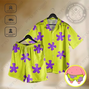 May include: A two-piece pyjama set with a short-sleeved button-down shirt and matching shorts. The set is lime green with large purple star-shaped patterns. A cartoon character is in the lower right corner.
