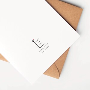 May include: A white card with a black and white illustration of a matchstick with the text "Larry the Match" and "Striking designs made in Wales".