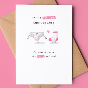 May include: A white card with a pink and white polka dot underwear and a white sock with a pink heel holding hands. The card says "Happy Cotton Anniversary" and "I'll always fancy the pants off you!"