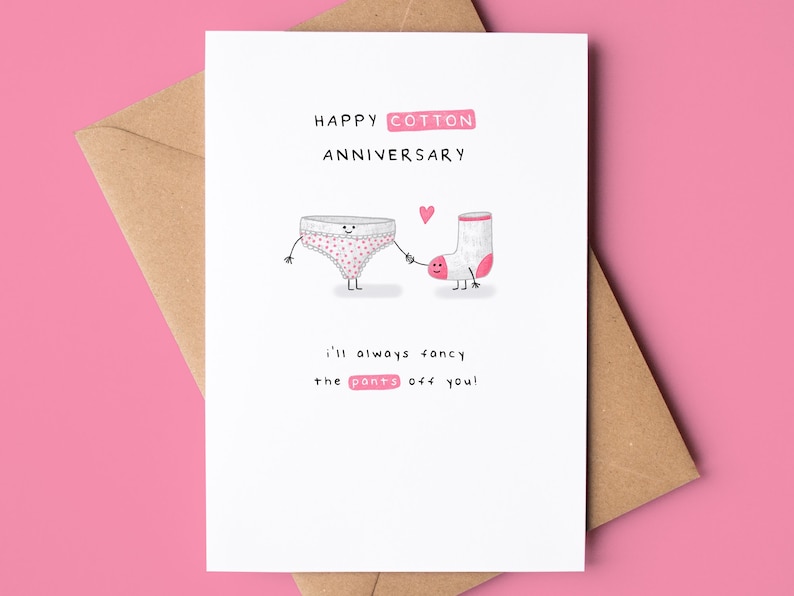 May include: A white card with a pink and white polka dot underwear and a white sock with a pink heel holding hands. The card says "Happy Cotton Anniversary" and "I'll always fancy the pants off you!"