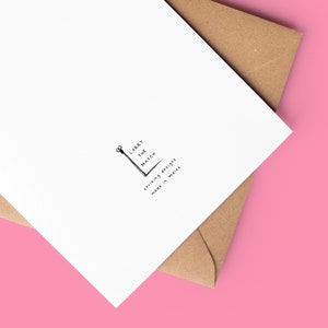 May include: A white card with a black and white illustration of a matchstick and the text "Larry the Match" and "Strikingly British, made in Wales".