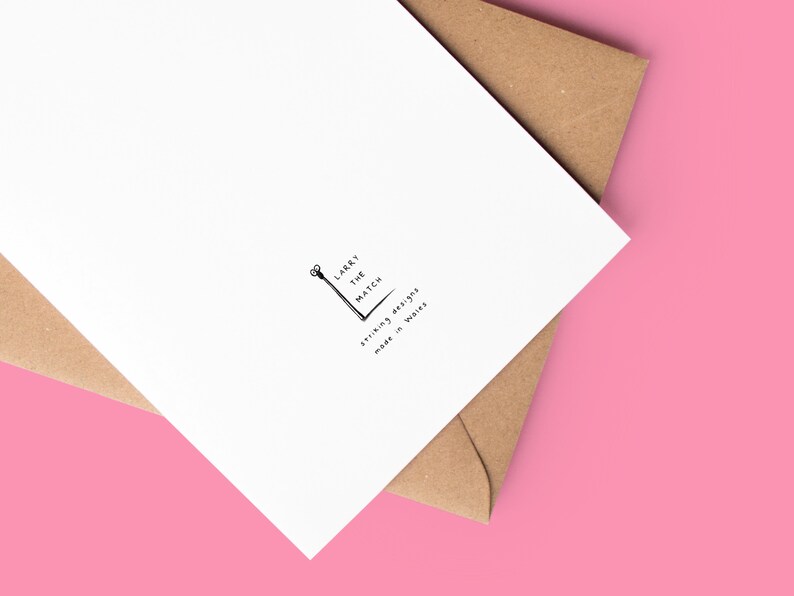 May include: A white card with a black and white illustration of a matchstick and the text "Larry the Match" and "Strikingly British, made in Wales".