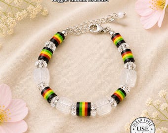 May include: A Reggae Riddim bracelet with a silver chain and clasp. The bracelet features alternating sections of black, red, yellow, and green beads, and clear, square-shaped beads. The text "URBAN STYLE ESSENTIALS" and "Reggae Riddim Bracelet" are visible.