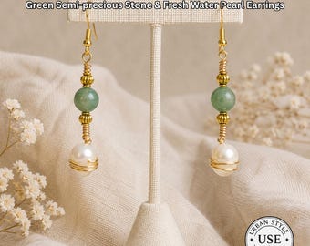 May include: Gold-toned earrings with green semi-precious stones and freshwater pearls. The earrings are displayed on a cream-colored stand. The text "URBAN STYLE ESSENTIALS" and "Green Semi-precious Stone & Fresh Water Pearl Earrings" are visible.