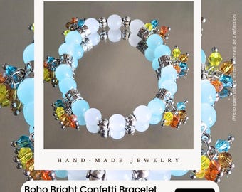 May include: A handmade Boho Bright Confetti bracelet. The bracelet features light blue and white glass beads, alloy spacers, and colorful glass bicones. The text "URBAN STYLE ESSENTIALS" and "HAND-MADE JEWELRY" are also visible.