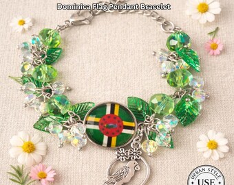 May include: A silver-toned bracelet with a Dominica flag pendant, green beads, and leaf accents. The bracelet features a round pendant with the Dominica flag design, a parrot charm, and the text "URBAN STYLE ESSENTIALS".