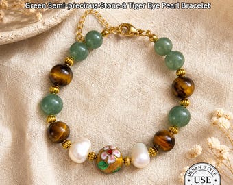 May include: A bracelet featuring green semi-precious stones, tiger eye beads, and pearls. The bracelet has gold-colored accents and a decorative floral bead. The text "URBAN STYLE ESSENTIALS" is at the top and bottom of the image.