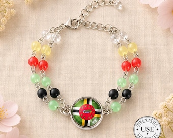 May include: A silver-toned bracelet with two strands of colorful beads. The beads are clear, yellow, red, green, and black. A round charm in the center features a flag design. The bracelet is adorned with the text "URBAN STYLE ESSENTIALS".