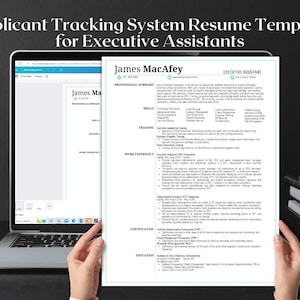 May include: A resume template for Executive Assistants is displayed on a laptop screen and held in front of the screen. The resume is titled "James MacAfey". A black mug, books, and the Canva logo are also visible.