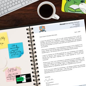 May include: A letter of resignation from Fircrest Elementary School is displayed on a spiral notebook. The letter is accompanied by sticky notes with handwritten messages and a cup of coffee. A computer keyboard and a frog-themed mousepad are also visible.