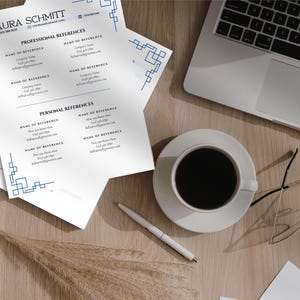 May include: A professional resume with the name "LAURA SCHMITT" at the top, along with contact information. The resume is on white paper with blue geometric design accents. A laptop, coffee cup, pen, and glasses are also on the wooden surface.