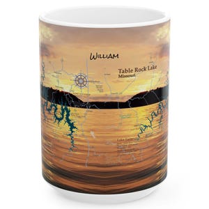 May include: White ceramic mug featuring a scenic sunset over Table Rock Lake, Missouri. The design includes a map of the lake and the name "William" in a handwritten font. The mug has a glossy finish.