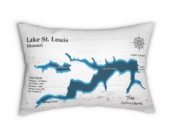 May include: A white rectangular cushion with a blue map of Lake St. Louis, Missouri. The cushion has the text "Lake St. Louis, Missouri" and "Lake Facts" with details about the lake. The text "The Williams" is at the bottom of the cushion.