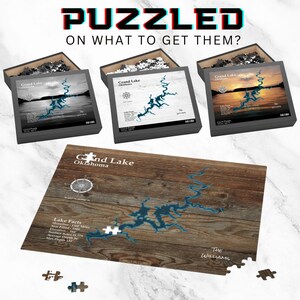 May include: Three different versions of a jigsaw puzzle featuring a map of Grand Lake, Oklahoma. The puzzles are in black and white, sepia tone, and color. The puzzle pieces are on a wooden surface. The text "Grand Lake Oklahoma" is printed on the puzzle box.