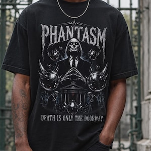 May include: Black t-shirt with the word "PHANTASM" in a distressed font above a detailed graphic. The graphic features a figure in a suit, surrounded by ornate elements and the text "DEATH IS ONLY THE DOORWAY."