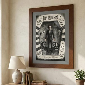 May include: Framed Tim Burton art print. The black and white artwork features a figure in a suit, surrounded by iconic imagery like a top hat, scissors, and a dog. The text "Tim Burton" is at the top, with the quote "I was never good at fitting in" at the bottom.