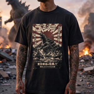 May include: Black t-shirt with a Godzilla graphic, Japanese text, and a rising sun design. The graphic shows Godzilla in a city with ships. Text includes "Godzilla" and "Tokyo Destruction Crisis!!".