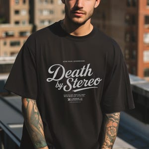 May include: Black t-shirt with a white graphic print that says "Death by Stereo" with the text "Good Night, Bloodsucker!" above it and "Sleep All Day, Party All Night, Never Grow Old, Never Die" below it. There is an "R" rating symbol below the text.