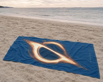 May include: A rectangular blue beach towel featuring a large, detailed graphic of a black hole with a glowing orange and yellow accretion disk. The text "do not go gentle" is printed in small white letters along the right side of the towel.