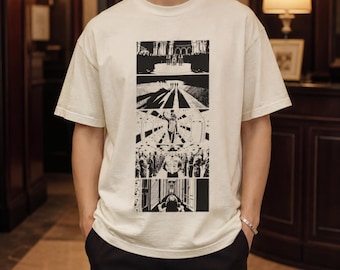 May include: An off-white short-sleeve t-shirt featuring a vertical graphic print on the chest. The design consists of five stacked black and white panels depicting various cinematic scenes, including figures on a stage, a long hallway, and a person.