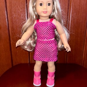 May include: A doll with long blonde hair wearing a pink sequined dress and pink boots.