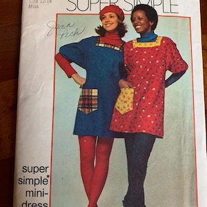 May include: Simplicity sewing pattern 5272 for a super simple mini-dress or smock. The pattern features two women modeling the dress. The pattern is for a medium size 12-14 Miss. The text "SUPER SIMPLE" is at the top.