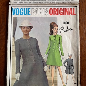 May include: Vintage Vogue Paris Original sewing pattern envelope, featuring a gray coat design and a green dress design. The envelope includes the number 1890 and the name Patou. The text reads "Vogue Paris Original".