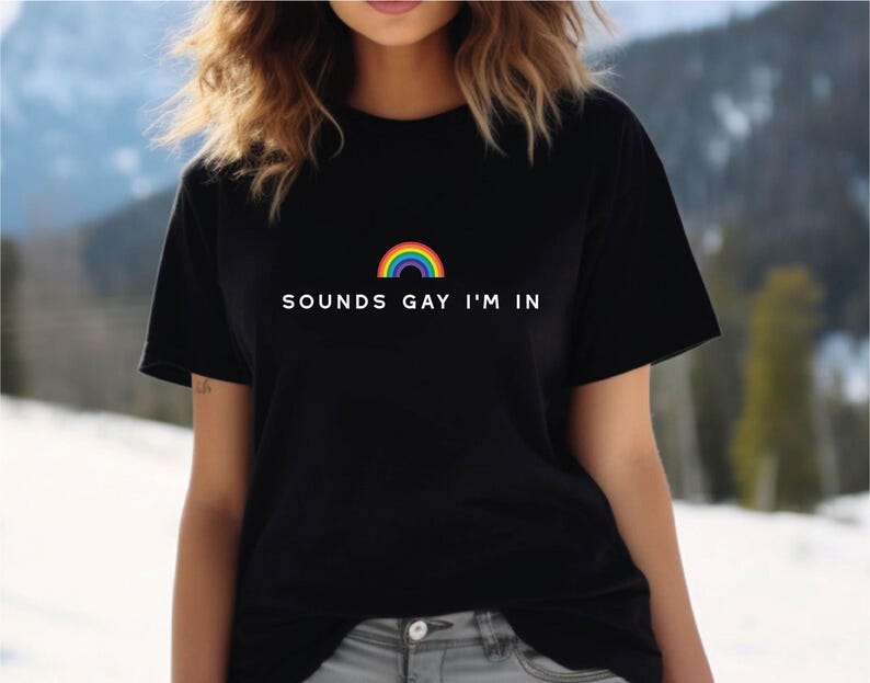May include: A black t-shirt with a rainbow graphic and the text 'SOUNDS GAY I'M IN'.