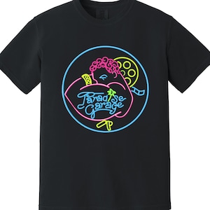 May include: Black t-shirt with a neon graphic. The graphic features a muscular figure with a film reel and the words "Paradise Garage" in a stylized font. The design is outlined in blue, pink, and yellow.